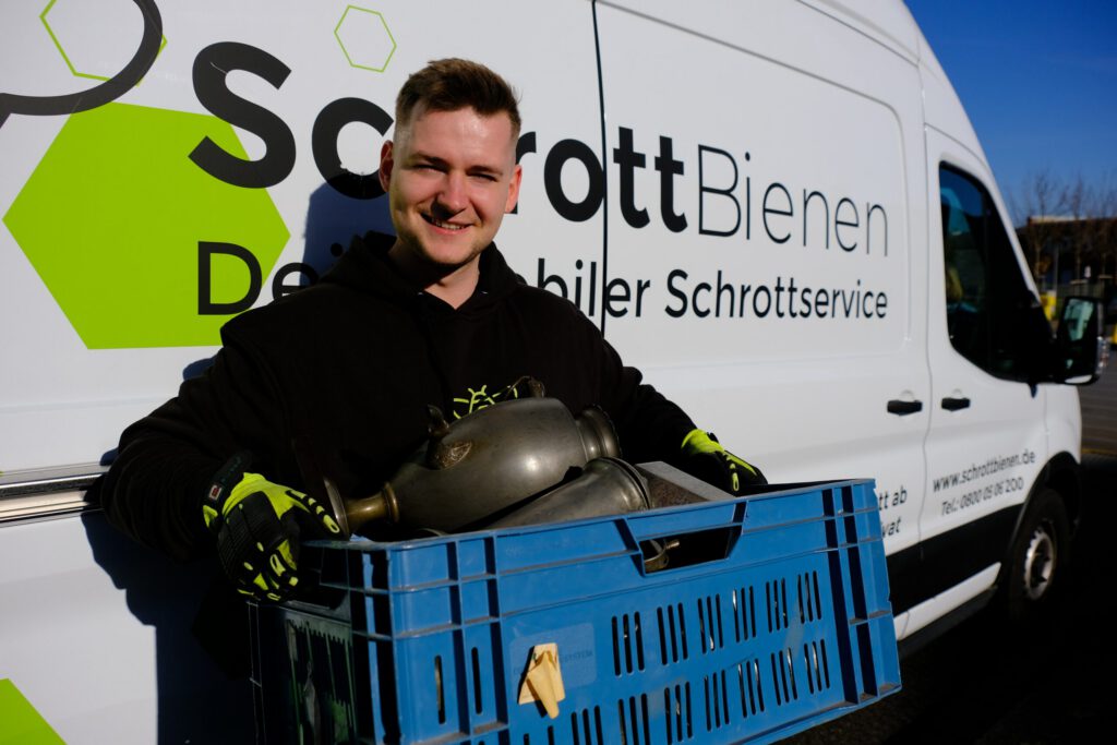 Das Bild zeigt einen Fahrer der SchrottBienen, nachdem eine Kundin ihr Zinn verkauft hat.